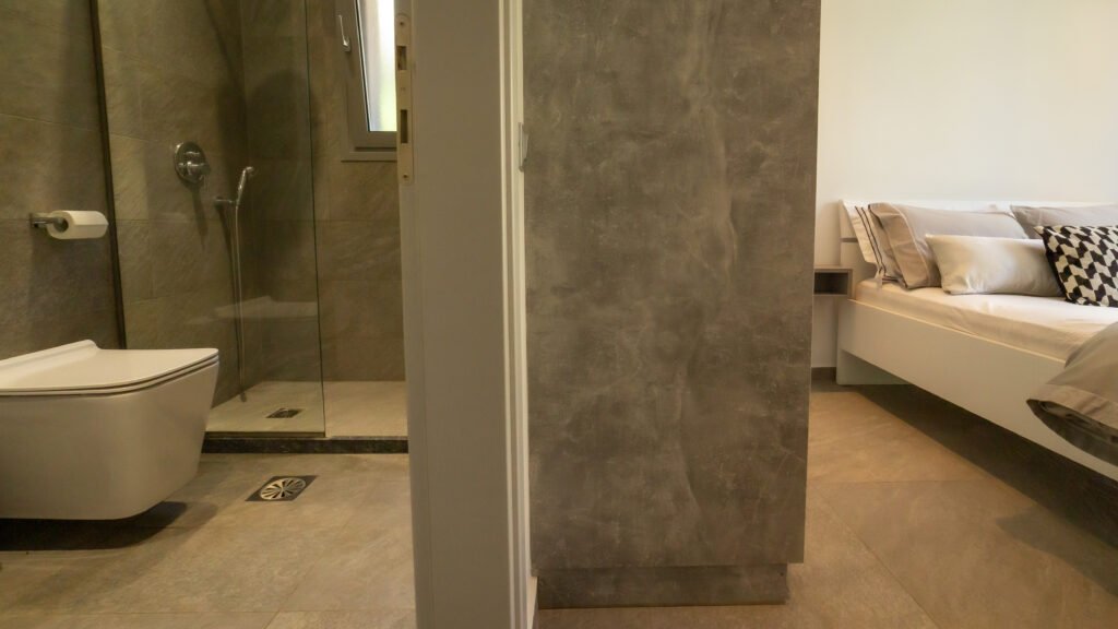 Gallery image depicting split view of bathroom and bedroom